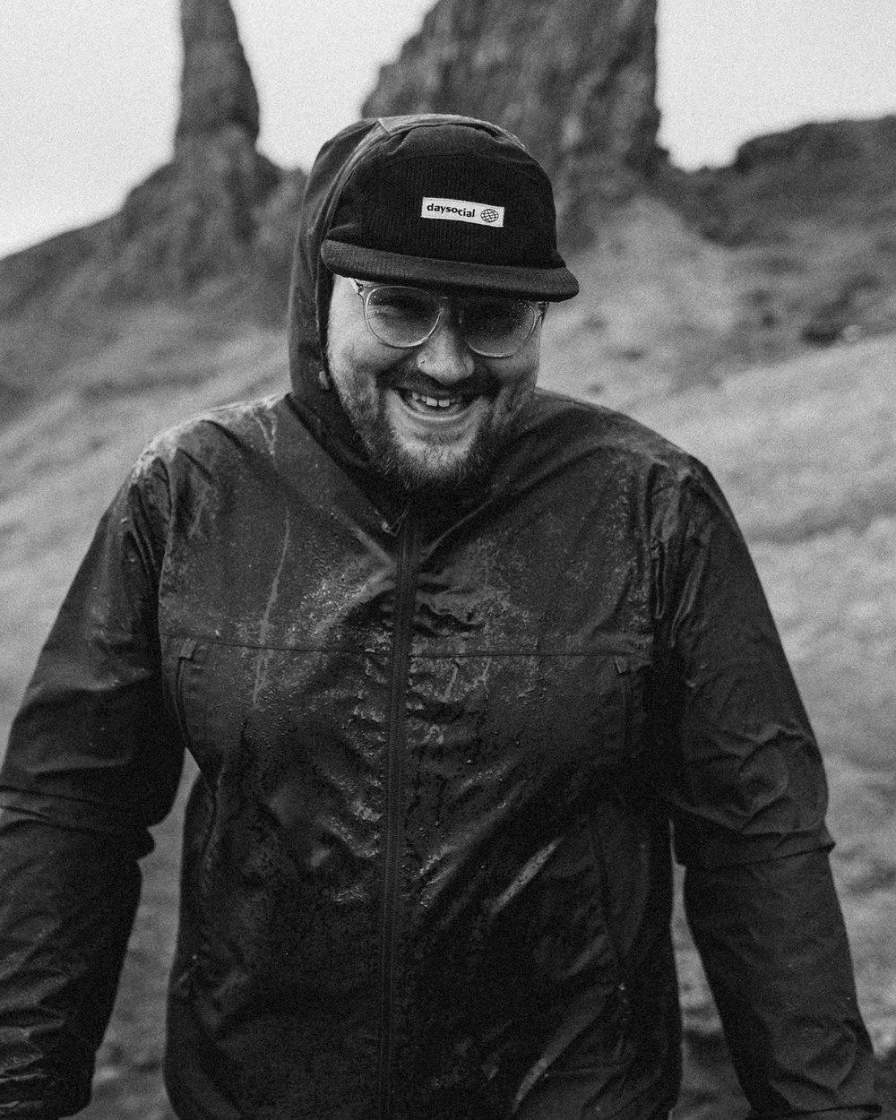 Portrait of Gavin, smiling in the rain on a hillside